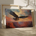 Framed canvas print of a majestic eagle in flight over a canyon at sunset with warm shades of orange and blue