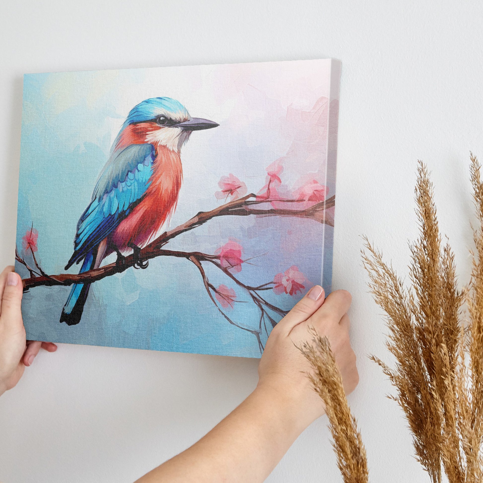 Framed canvas print of a colourful Kingfisher bird on a branch with pink cherry blossoms against a soft blue sky