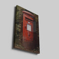 Framed canvas print of a classic British red postbox surrounded by greenery