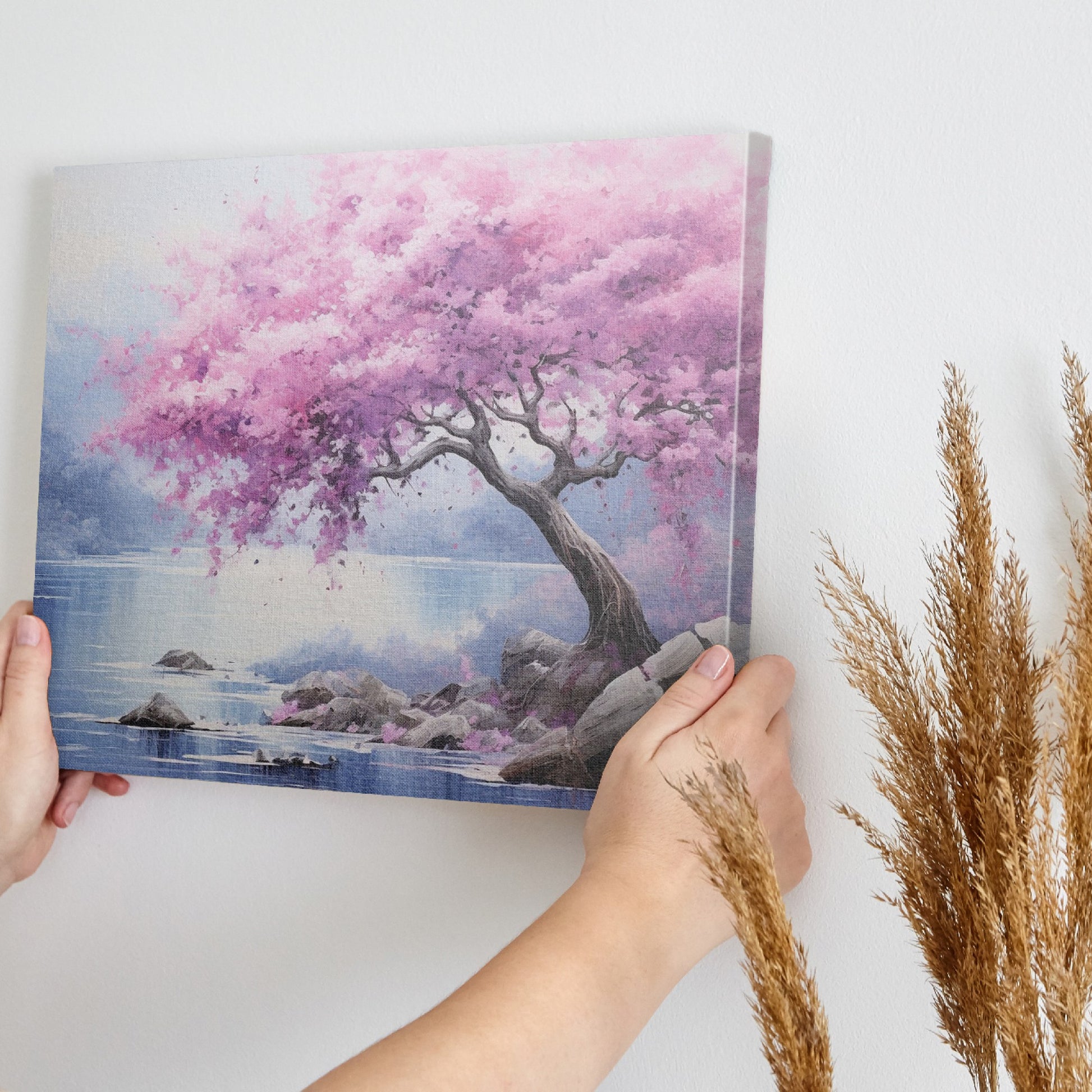 Framed canvas print of a cherry blossom tree by a lake with vivid pink flowers and tranquil blue waters