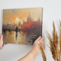 Framed canvas print of an impressionistic cityscape at sunset with reflections on a river