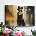 Framed canvas print of an elegant woman in a black dress with a sepia-toned urban street scene background