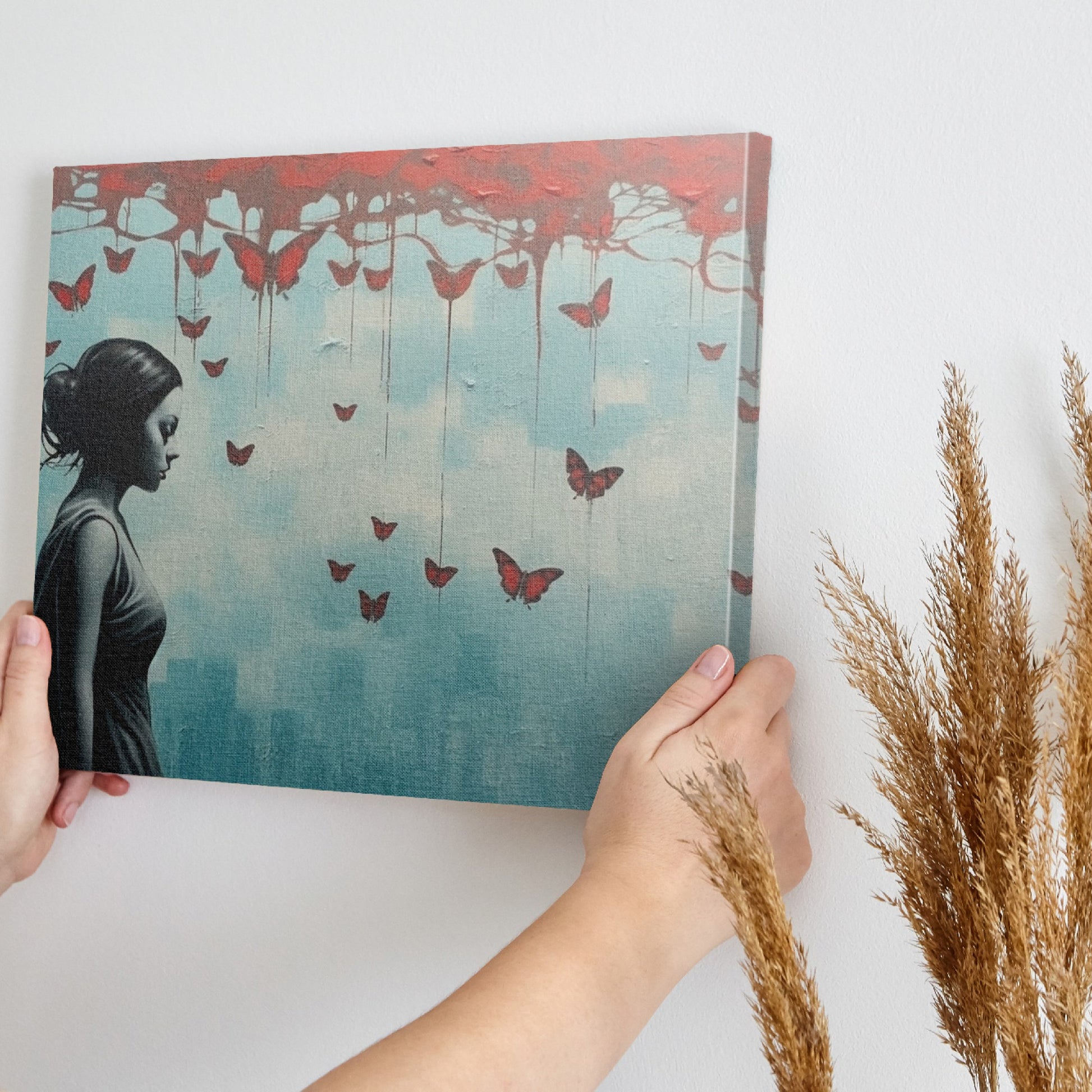 Framed canvas print of a female silhouette with red butterflies against an urban backdrop