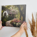 Framed canvas print of a picturesque cottage surrounded by blooming garden and shaded by trees