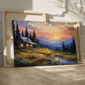 Framed canvas print of a rustic cabin at sunset with a mountainous backdrop