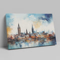 Framed canvas print of abstract watercolour cityscape with vibrant blue, orange and black tones