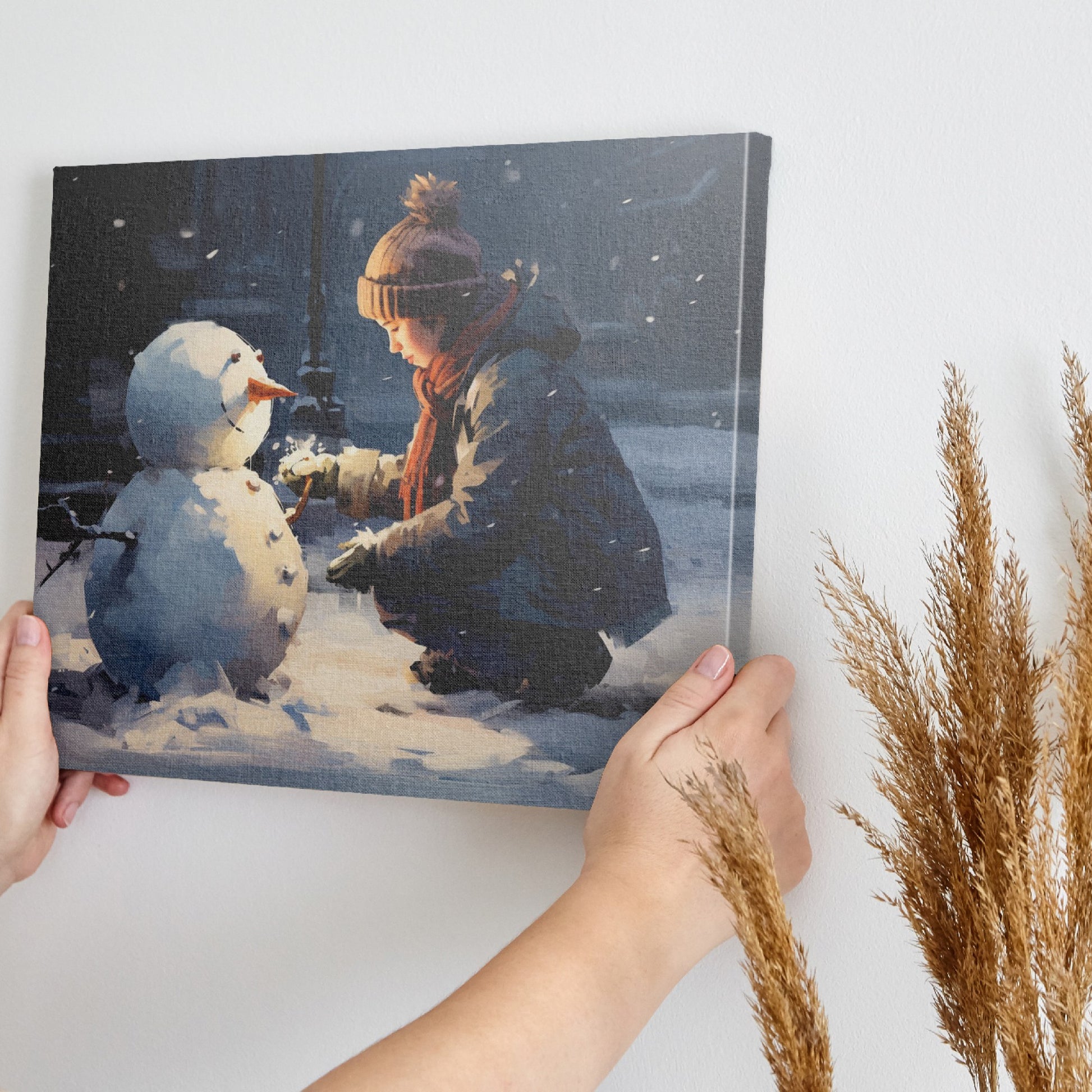 Framed canvas print of a child building a snowman on a snowy city evening