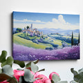 Framed canvas print of stylised Tuscan village landscape with pastel countryside and purple floral field