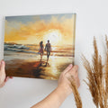 Framed canvas print of romantic couple silhouetted against a vibrant beach sunset