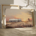 Framed canvas print of a rustic barn surrounded by tranquil fields at sunset, with warm golden and earthy tones.