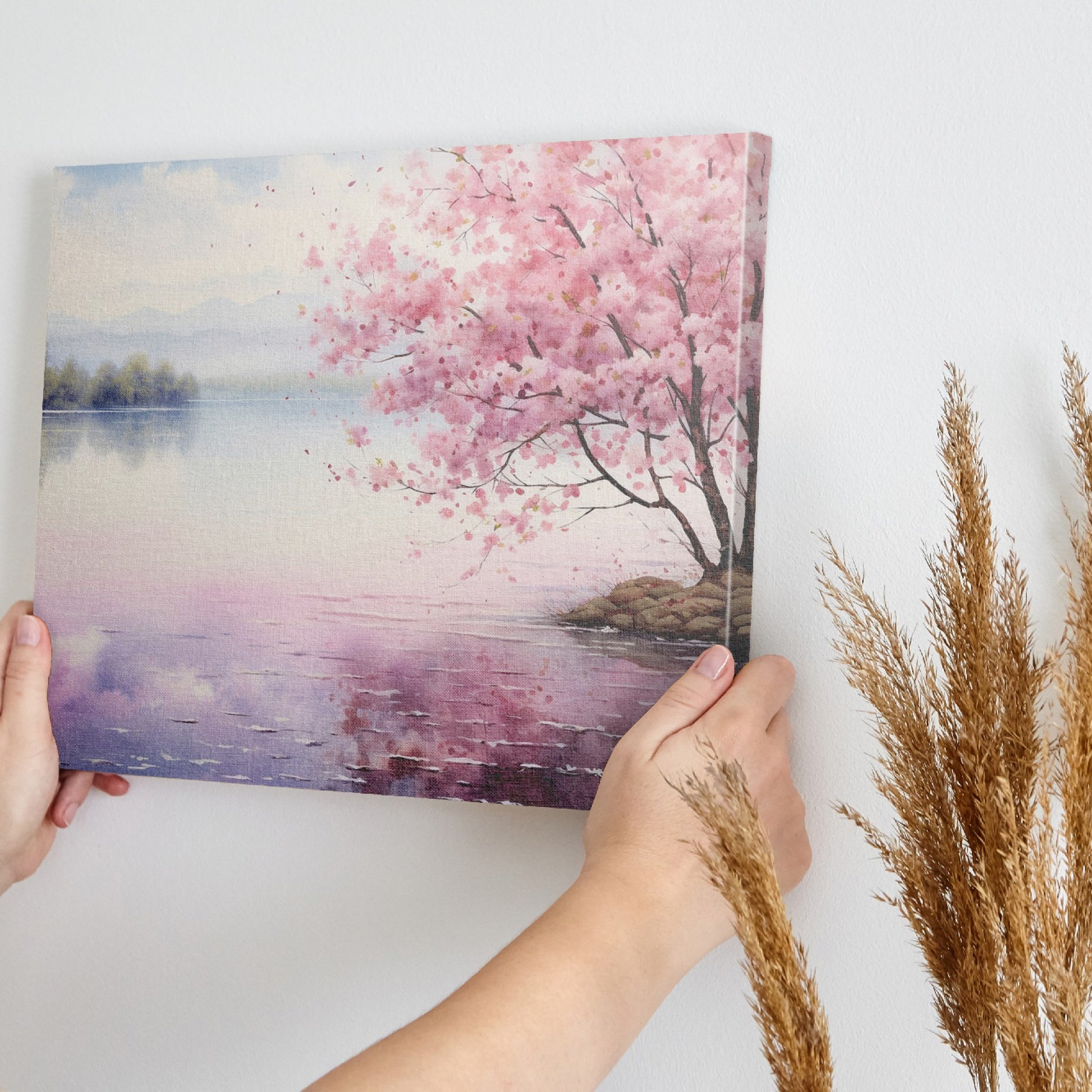 Framed canvas print of a serene cherry blossom tree by a quiet lake with pink and purple reflections