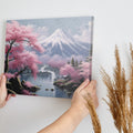 Framed canvas print of a serene Japanese landscape with pink cherry blossoms and Mount Fuji