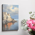 Framed canvas print of a Mediterranean coastal village during sunset with golden reflections on water