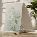 Framed canvas print of delicate white blossoms with a pastel background