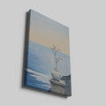 Canvas print of a tranquil ocean view with a blossoming plant in a vase on a ledge