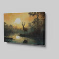 Framed canvas print of a majestic stag against a forest lake at sunrise with orange skies