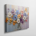 Framed canvas print of vibrant impasto painted flowers in a vase with rich textures and a colourful palette