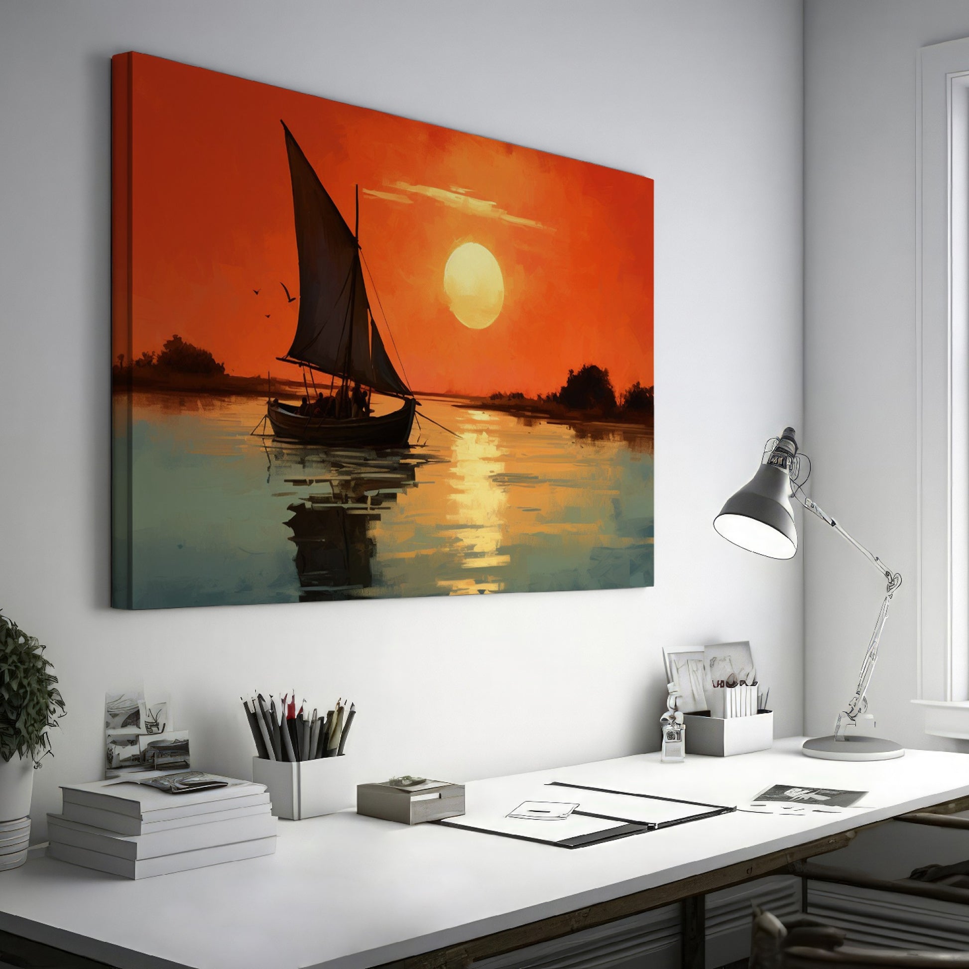 Framed canvas print of a sailboat against an orange sunset with water reflections