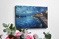 Framed canvas print of twilight seascape with vivid blue waters and illuminated harbour lights