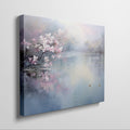 Framed canvas print of cherry blossoms over a tranquil lake with soft pastel colours and a pair of ducks