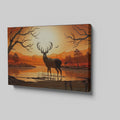 Printed canvas art of a black deer silhouette against an orange sunset with trees and mountains