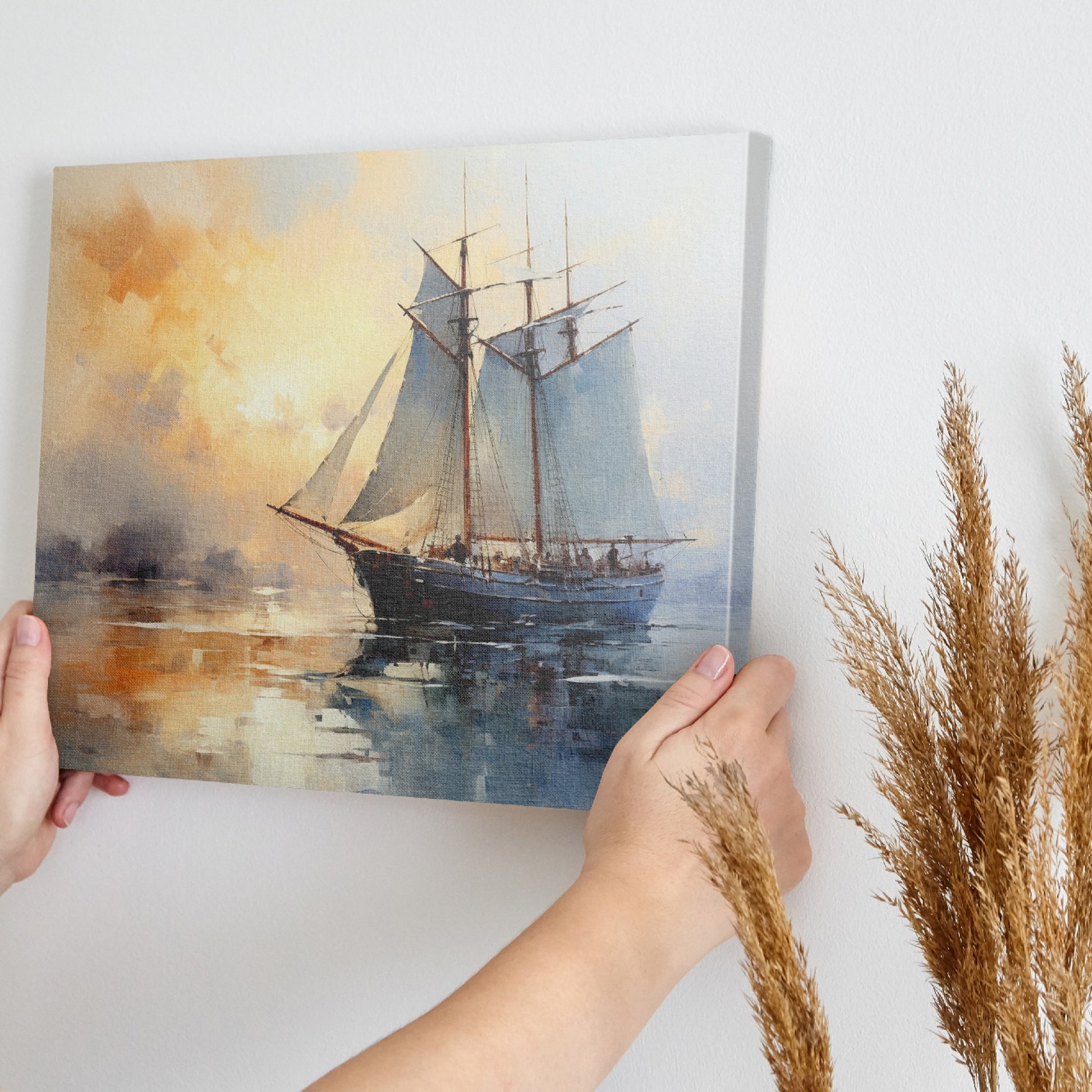 Framed canvas print of an impressionist-style sailing ship at sea during a warm, golden sunset with reflections on the water