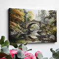 Framed canvas print of a tranquil autumnal scene featuring a rustic stone bridge over a serene river with lush forest in the background