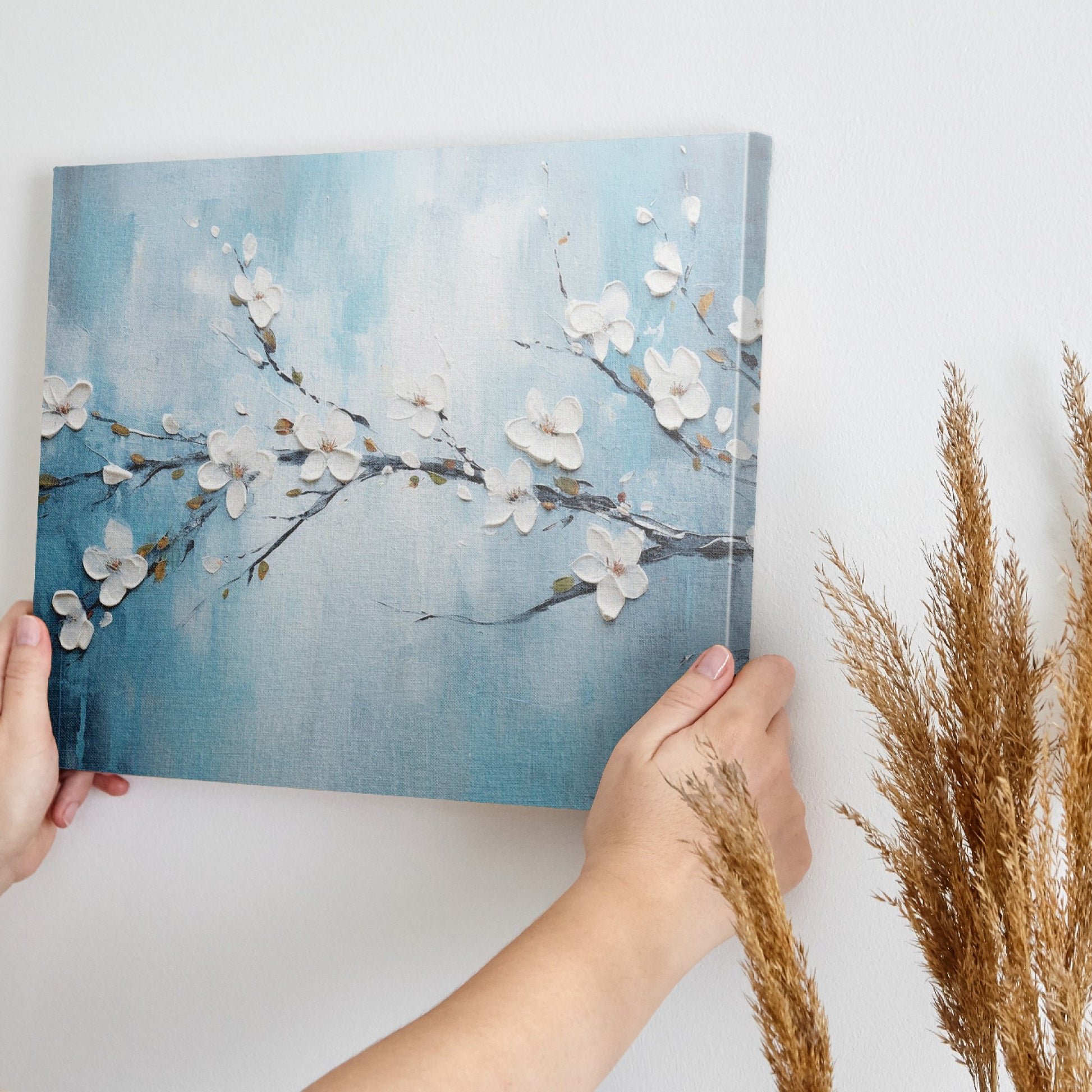 Framed canvas print of serene cherry blossoms with impasto texture on blue background