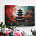 Framed canvas print of an oriental pagoda in crimson and teal colours with moonlit scenery