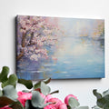 Framed canvas print of a serene impressionist painting with cherry blossoms and river reflections