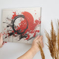 Framed canvas print of explosive red and black abstract art with dynamic splatters and bold strokes