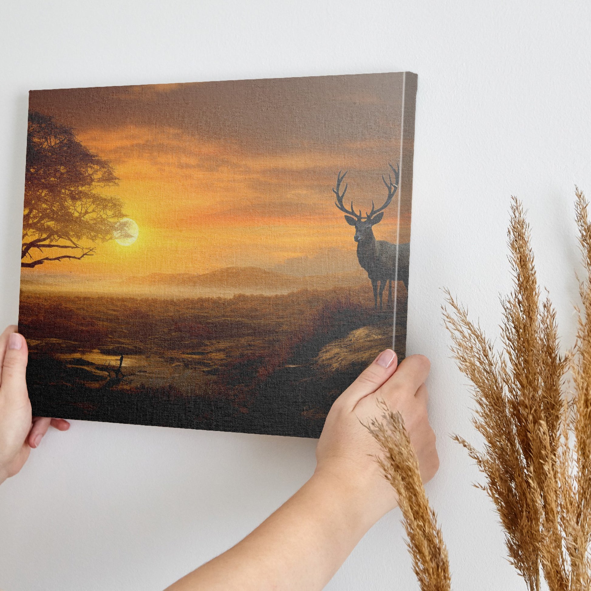 Framed canvas print of a majestic stag in a savanna sunset landscape with warm orange hues