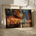 Framed canvas print of an impressionistic cityscape at twilight with a café terrace and bustling streets