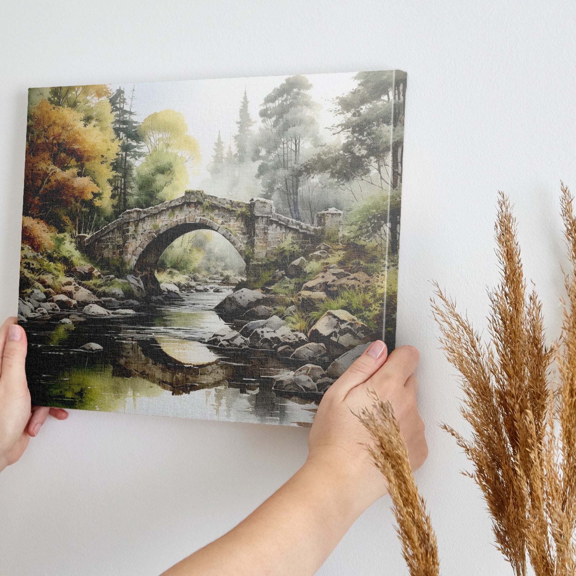 Framed canvas print of a tranquil autumnal scene featuring a rustic stone bridge over a serene river with lush forest in the background