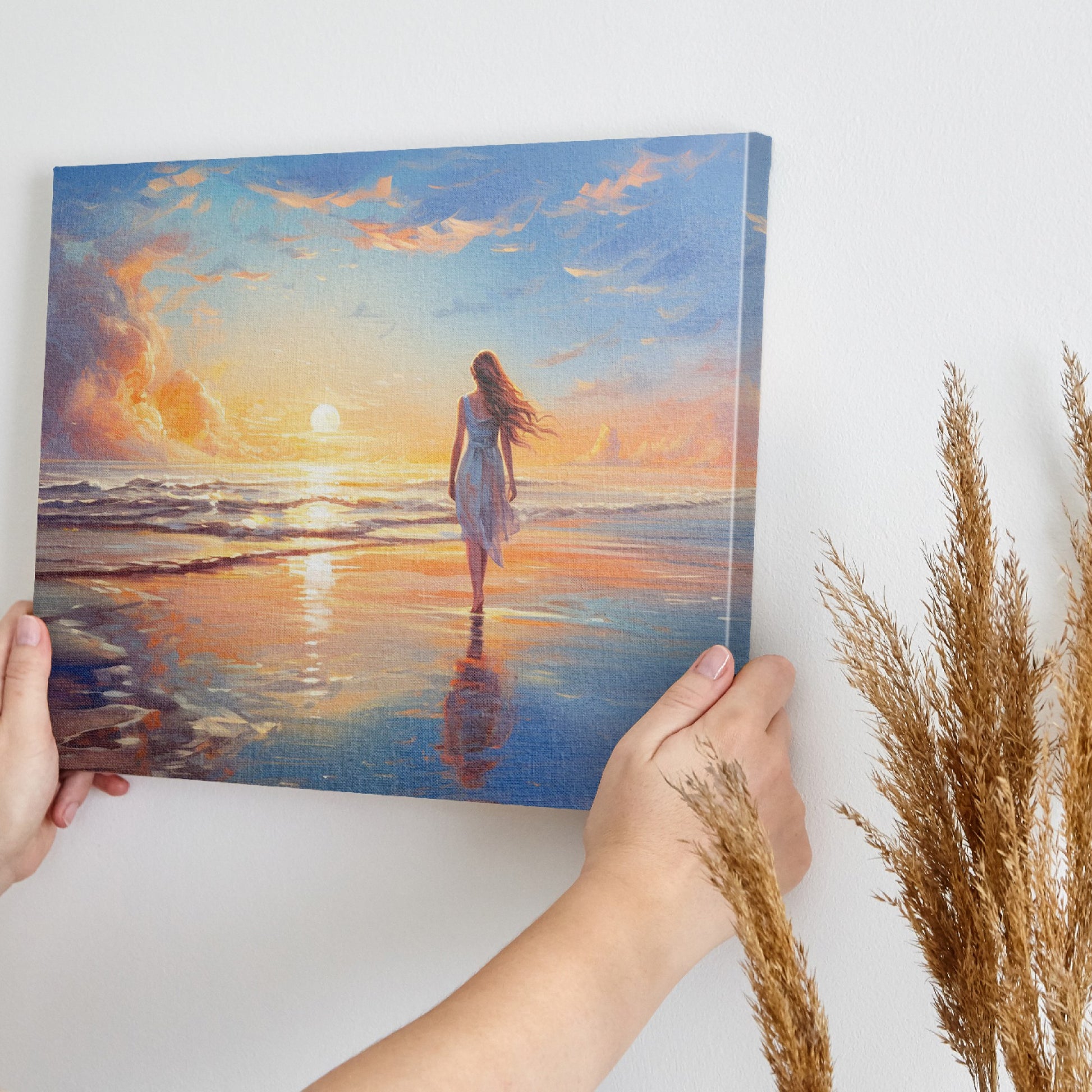 Framed canvas print of a woman walking on the beach at sunset with vibrant skies reflected in the water