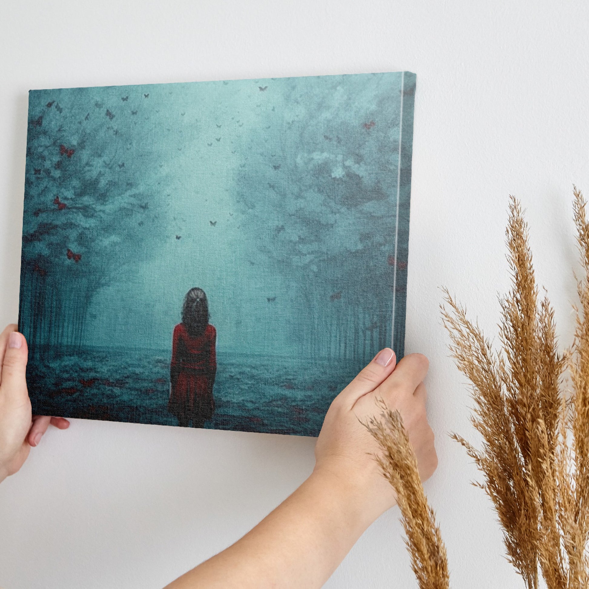 Framed canvas print of a girl in red standing in a mystical blue forest with butterflies