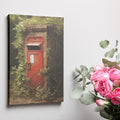 Framed canvas print of a vintage British red postbox entwined with green foliage in a forest