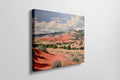 Framed canvas print of impressionistic desert hills with vivid red, earthy beige, and lush green tones