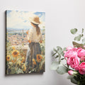 Framed canvas print of a woman gazing over a sunflower field and vintage town