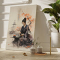 Framed canvas print of a serene Japanese woman in kimono participating in a tea ceremony with cherry blossoms and pagoda in the background