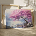 Framed canvas print of a cherry blossom tree by a lake with vivid pink flowers and tranquil blue waters