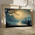 Framed canvas print of a serene Oriental landscape with a meditative figure under a tree against a sunrise backdrop