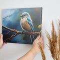 Framed canvas print of a realistic blue jay perched on a branch with intricate detail and vibrant colours