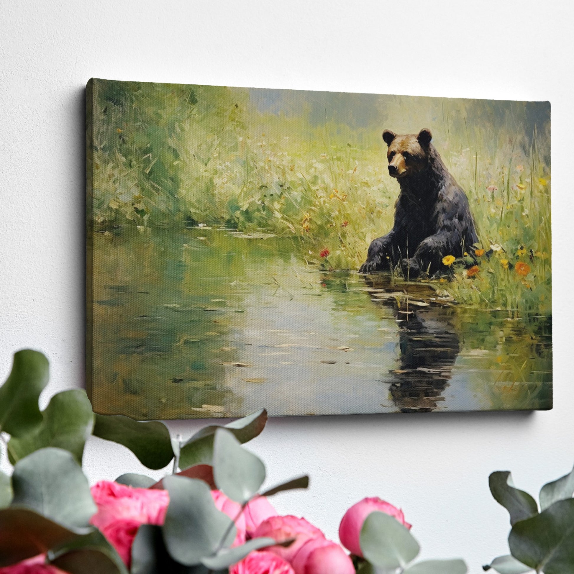 Framed canvas print of a bear sitting by a pond with floral surroundings