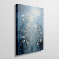 Framed canvas print of ethereal blue abstract painting with white flowers and a woman's silhouette