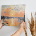 Framed canvas print of impressionist river landscape at sunset with vibrant orange and blue hues