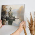 Framed canvas print of a serene Buddha in meditation with a reflective water landscape and autumnal trees