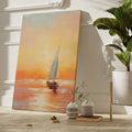 Framed canvas print of impressionistic sailboat at sunset with warm golden and orange tones