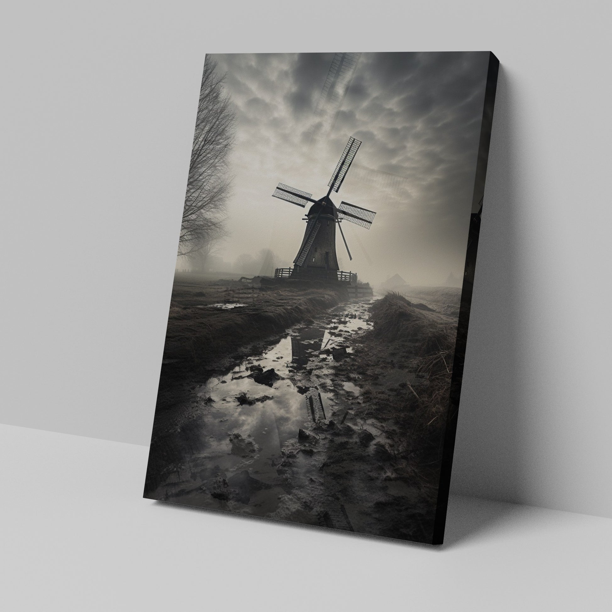 Framed canvas print of a misty Dutch windmill landscape with dramatic sky and reflection in puddle