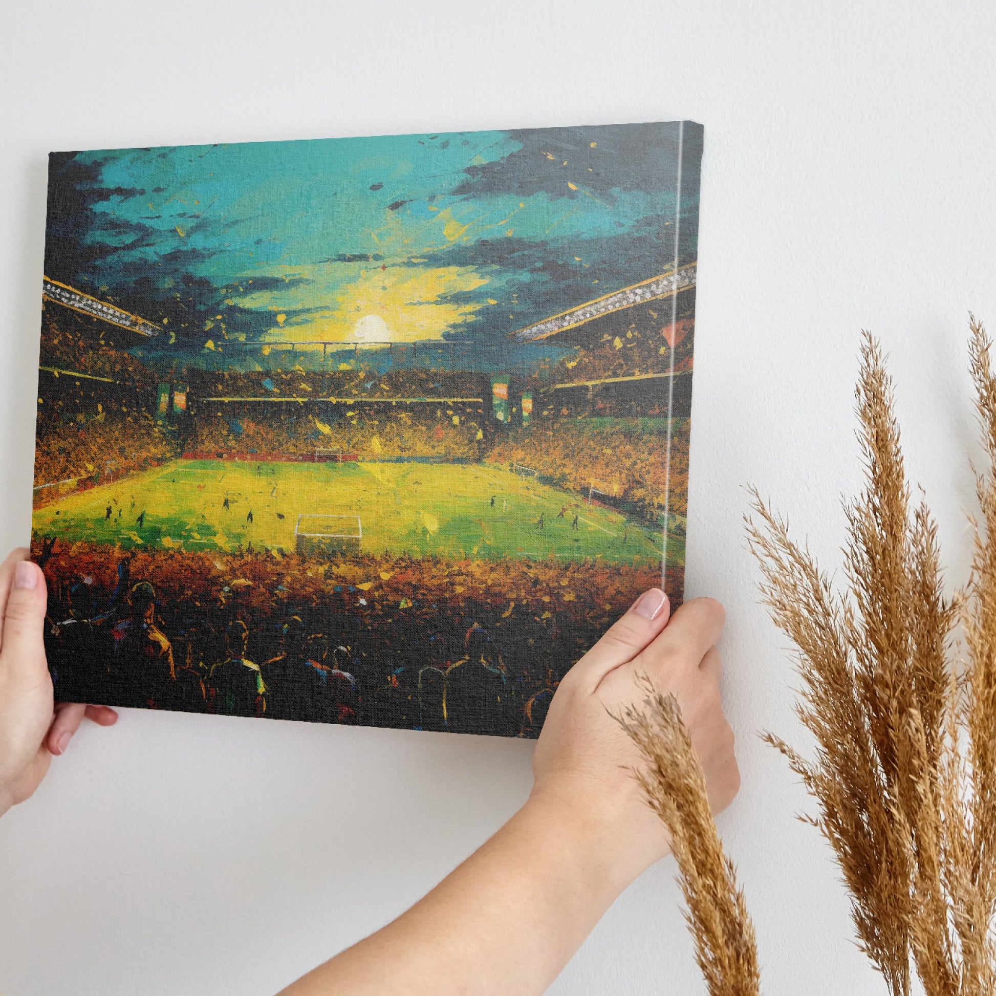 Framed canvas print of an impressionist painting capturing a football match at sunset with a cheering crowd